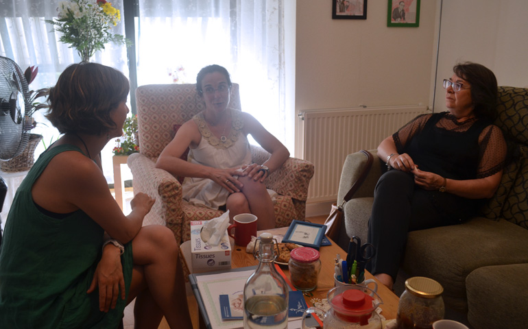 Pilar, Elena y Laura en casa de la primera. Sobre la mesa, un cuadro con las huellas de Camilo, el hijo de Pilar