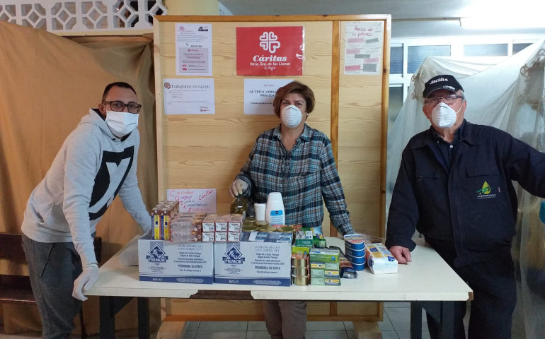 Unos voluntarios en el reparto de alimentos en Cáritas El Algar (Murcia)