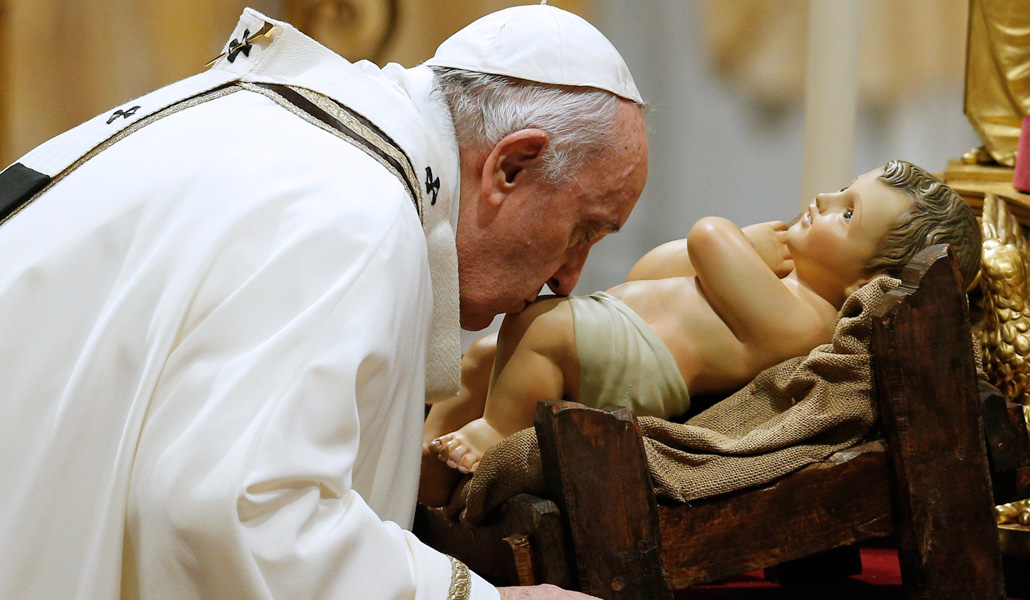 El Papa besa la imagen del Niño Jesús durante la Misa del Gallo, en la basílica de San Pedro del Vaticano