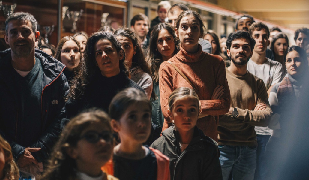 Voluntarios y niños esperando a repartir el material en una de las ediciones