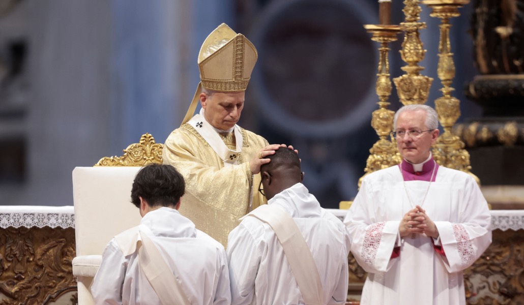 El Papa impone las manos a dos de los ordenandos.